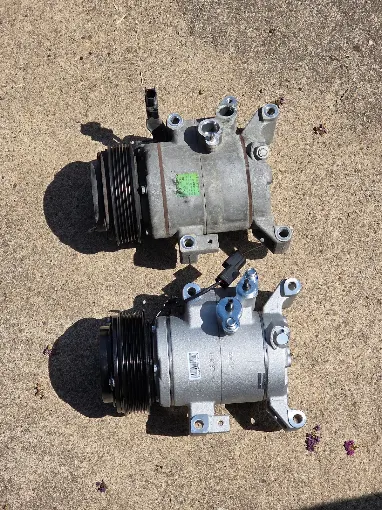 Two automotive A/C compressors shown side by side