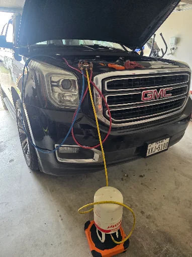 Pickup truck connected to A/C service gauges