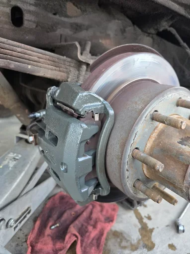 Front brake caliper and rotor during service