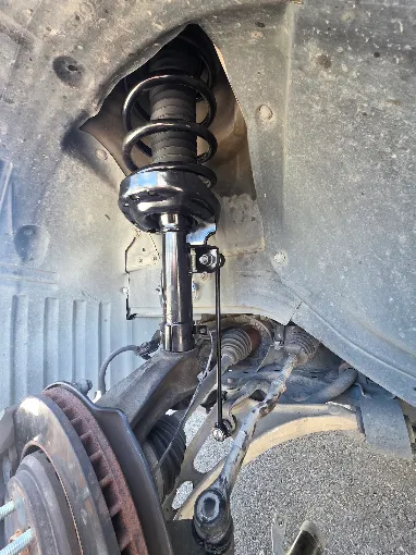 Front suspension strut and brake assembly during service