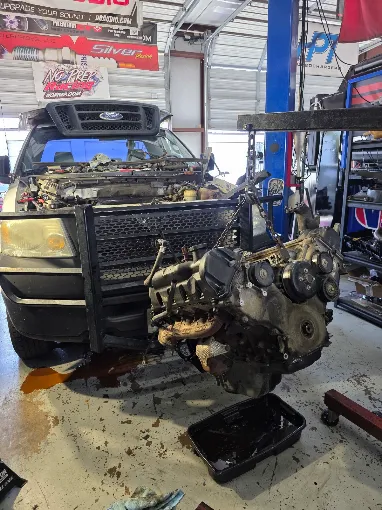 Vehicle with the engine removed during mechanical work inside a shop